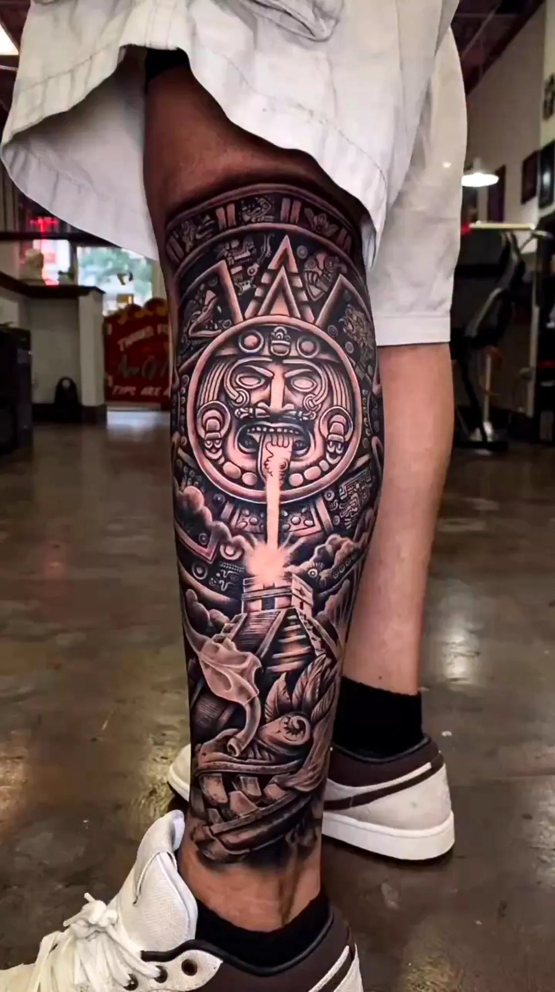 black and grey aztec calendar leg sleeve tattoo by Steve Bachman, Long Beach