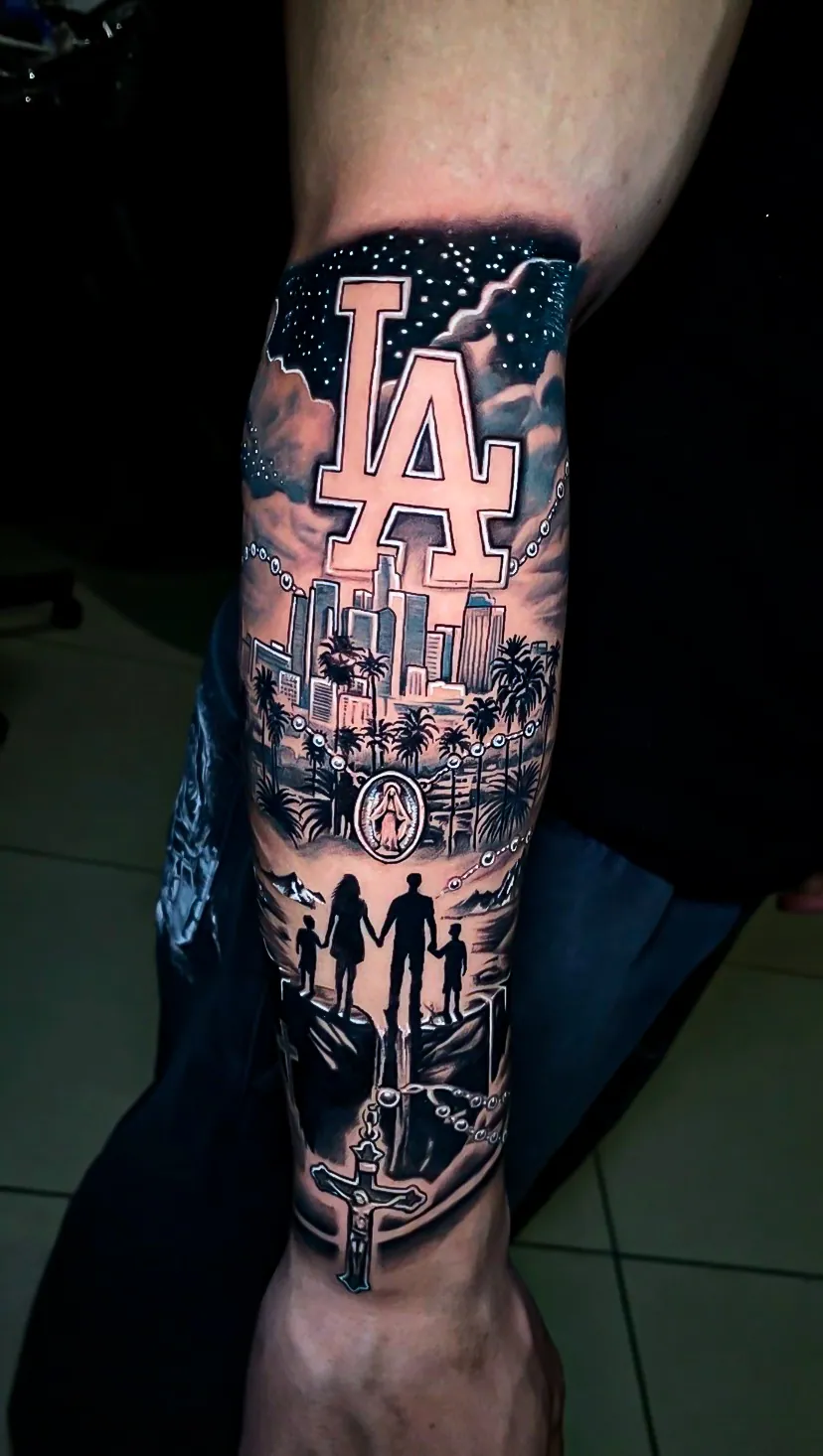 black and grey Los Angeles skyline forearm tattoo by Steve Bachman, Long Beach